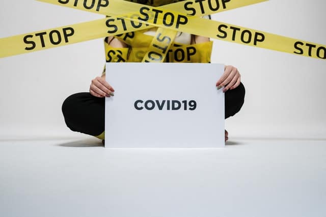 person holding covid 19 sign